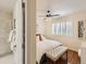 Relaxing main bedroom featuring hardwood floors, shuttered windows, and an ensuite bathroom with a tiled shower at 11275 Holly St, Thornton, CO 80233