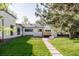 Spacious backyard has a patio, deck, luscious lawn, and garden area, perfect for outdoor relaxation at 13905 Berry Rd, Golden, CO 80401