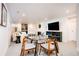 Finished basement space with dining table, sleek TV, and comfortable white sofa at 13905 Berry Rd, Golden, CO 80401