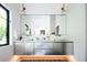 Modern bathroom showcasing a sleek vanity with double sinks, stainless steel cabinets and under cabinet lighting at 13905 Berry Rd, Golden, CO 80401