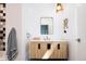 Modern bathroom showcasing a vanity with light wood cabinets and a rectangular mirror at 13905 Berry Rd, Golden, CO 80401