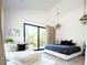 Bright bedroom with a modern bed, stylish chaise lounge, and a sliding door with a scenic outdoor view at 13905 Berry Rd, Golden, CO 80401