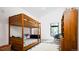 Bright bedroom featuring wood bunk beds, plush rug and decorative storage cabinet at 13905 Berry Rd, Golden, CO 80401