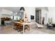 Open-concept dining room and kitchen area featuring modern pendant lighting and light-colored hardwood floors at 13905 Berry Rd, Golden, CO 80401