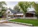 Landscaped front yard featuring a modern home with black framed windows and a covered porch area at 13905 Berry Rd, Golden, CO 80401