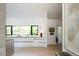 Modern kitchen featuring sleek white cabinets, an eat-in island, and a large window with a lush green view at 13905 Berry Rd, Golden, CO 80401