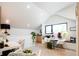Bright living space with vaulted ceiling, window seat, and hardwood floors at 13905 Berry Rd, Golden, CO 80401