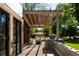 Inviting outdoor lounge area with a covered pergola and custom-built seating at 13905 Berry Rd, Golden, CO 80401