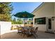 Charming patio area with outdoor dining set, seating, and brick accents at 13905 Berry Rd, Golden, CO 80401