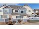 Townhouse with a blue front door and stone accents at 15800 E 121St Ave # 5F, Brighton, CO 80603