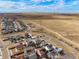 Aerial view showing home, neighborhood, and distant mountain views at 334 Feather Pl, Lochbuie, CO 80603