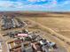 Aerial view showing home, neighborhood, and distant mountain views at 334 Feather Pl, Lochbuie, CO 80603