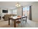 Dining area with table and chairs near living room and sliding glass doors at 334 Feather Pl, Lochbuie, CO 80603