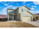 Two-story house with light green exterior, two-car garage, and landscaping at 334 Feather Pl, Lochbuie, CO 80603