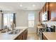 Kitchen with wooden cabinets, stainless steel appliances, and an island at 334 Feather Pl, Lochbuie, CO 80603