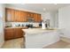 Kitchen with wooden cabinets, stainless steel appliances, and an island at 334 Feather Pl, Lochbuie, CO 80603