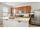 Kitchen with wooden cabinets, stainless steel appliances, and an island at 334 Feather Pl, Lochbuie, CO 80603