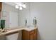 Clean bathroom with single sink vanity and updated light fixture at 3836 Garnet Way, Highlands Ranch, CO 80126