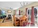 Bright dining area with wood table and chairs, adjacent to living room and kitchen at 3836 Garnet Way, Highlands Ranch, CO 80126