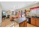 Open concept kitchen with an island and views into the living and dining areas at 3836 Garnet Way, Highlands Ranch, CO 80126