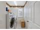 Laundry room with washer, dryer, and shelving at 3836 Garnet Way, Highlands Ranch, CO 80126