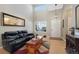 Two-story living room with hardwood floors, high ceilings, and a large window at 3836 Garnet Way, Highlands Ranch, CO 80126