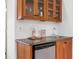 Mini bar with wooden cabinets, granite countertop, a wine rack and a mini refrigerator at 4185 Red Rock Dr, Larkspur, CO 80118