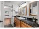 Bathroom offers black granite counters and wood cabinets at 4185 Red Rock Dr, Larkspur, CO 80118