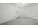Bright bedroom featuring a window, gray carpet and neutral colored walls at 4185 Red Rock Dr, Larkspur, CO 80118