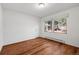 Bedroom with two windows and plank flooring at 4185 Red Rock Dr, Larkspur, CO 80118