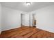 A primary bedroom offers plank flooring and ensuite bathroom access at 4185 Red Rock Dr, Larkspur, CO 80118