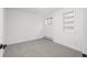 A bright bedroom featuring a window, gray carpet and built in shelves at 4185 Red Rock Dr, Larkspur, CO 80118