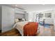 Bedroom with murphy bed, wood floors, and exercise equipment by a window at 4185 Red Rock Dr, Larkspur, CO 80118