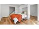 Bedroom with wood floors, murphy bed, and access to stairs at 4185 Red Rock Dr, Larkspur, CO 80118