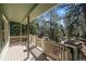 Well-maintained wood deck surrounded by tall green trees at 4185 Red Rock Dr, Larkspur, CO 80118