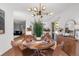 Open dining room featuring hardwood floors, seating for four, and an entryway into the kitchen at 4185 Red Rock Dr, Larkspur, CO 80118