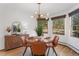 Bright dining room with a modern chandelier, a round table, and large windows at 4185 Red Rock Dr, Larkspur, CO 80118
