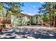 Charming two-story home with a spacious driveway and a lush green lawn, complemented by a two-car garage at 4185 Red Rock Dr, Larkspur, CO 80118