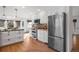 A modern kitchen features stainless appliances, bright lighting and great flow to the dining area at 4185 Red Rock Dr, Larkspur, CO 80118