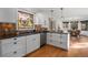 An eat-in kitchen offers stainless appliances and granite countertops with views to the dining area at 4185 Red Rock Dr, Larkspur, CO 80118