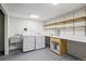 Laundry room featuring a sink, washer and dryer and folding table with shelving at 4185 Red Rock Dr, Larkspur, CO 80118