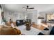 Bright living room featuring hardwood floors, modern furniture, and a ceiling fan at 4185 Red Rock Dr, Larkspur, CO 80118