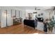 Hardwood floors flow through the living room with modern furniture and open floor plan to dining at 4185 Red Rock Dr, Larkspur, CO 80118