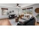 Bright living room featuring hardwood floors, multiple sofas, and natural light from large windows at 4185 Red Rock Dr, Larkspur, CO 80118