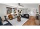 Cozy living room featuring hardwood floors, two sofas, and natural light from large windows at 4185 Red Rock Dr, Larkspur, CO 80118