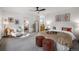 Spacious main bedroom with plush carpet, ceiling fan, walk-in closet, and ensuite bathroom at 4185 Red Rock Dr, Larkspur, CO 80118