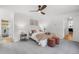 Bright main bedroom boasts a ceiling fan, a king bed, and neutral décor at 4185 Red Rock Dr, Larkspur, CO 80118