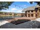 View of the Pro Shop with a deck and railing overlooking a lake in a mountain setting at 4185 Red Rock Dr, Larkspur, CO 80118