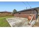 Brick home exterior showcasing a concrete patio and a fenced-in yard with grass at 925 Wolff St, Denver, CO 80204