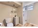 Well-lit bathroom with a modern vanity, toilet, and a glass-enclosed shower at 925 Wolff St, Denver, CO 80204